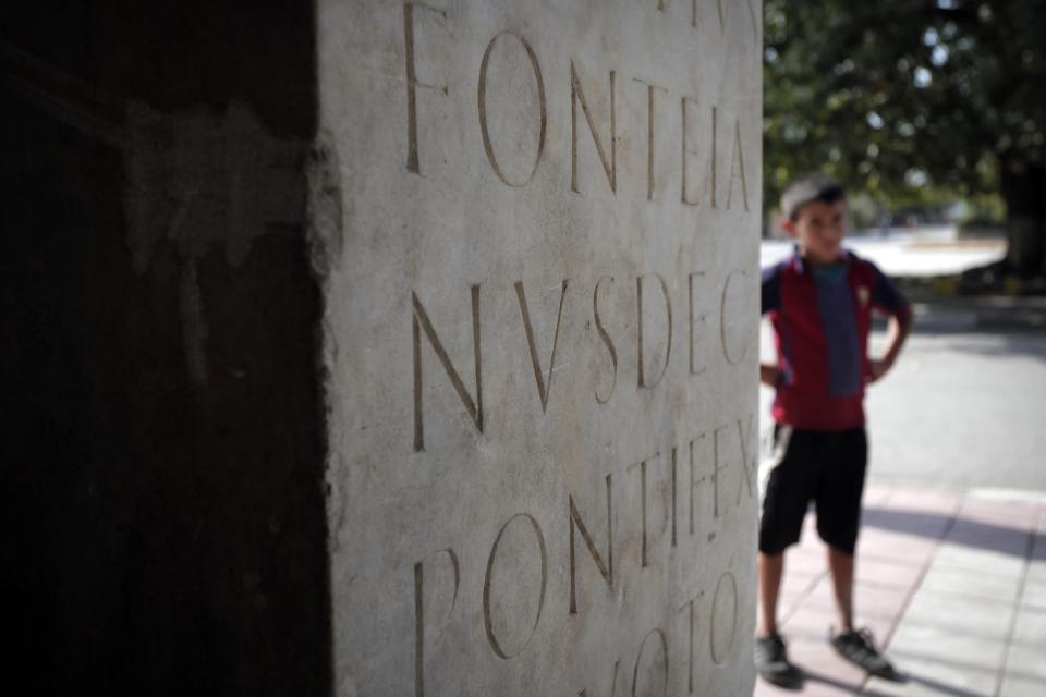 This Friday, Oct. 5, 2012 photo shows part of ancient Roman inscription on a column, found on the site of Ratiaria, an ancient Roman settlement located on the banks of the Danube, in the northwest corner of Bulgaria. Located on the crossroads of many ancient civilizations, Bulgarian scholars rank their country behind only Italy and Greece in Europe for the numbers of antiquities lying in its soil. But Bulgaria has been powerless to prevent the rape of its ancient sites, depriving the world of part of its cultural legacy and also costing this impoverished Balkan nation much-needed tourism revenue. (AP Photo/Valentina Petrova)