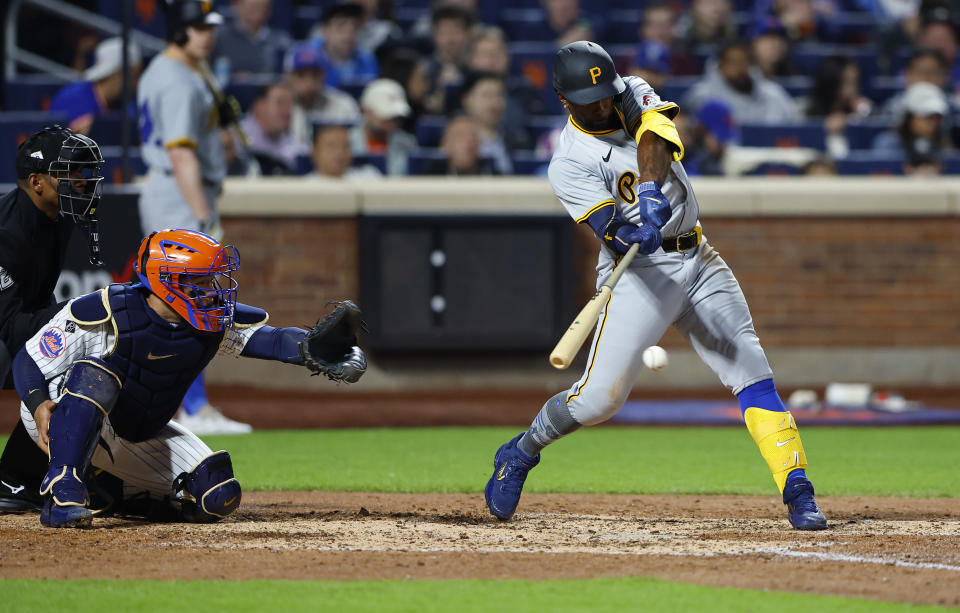 Pittsburgh Pirates' Andrew McCutchen, right, hits a single against the New York Mets during the sixth inning of a baseball game, Monday, April 15, 2024, in New York. (AP Photo/Noah K. Murray)