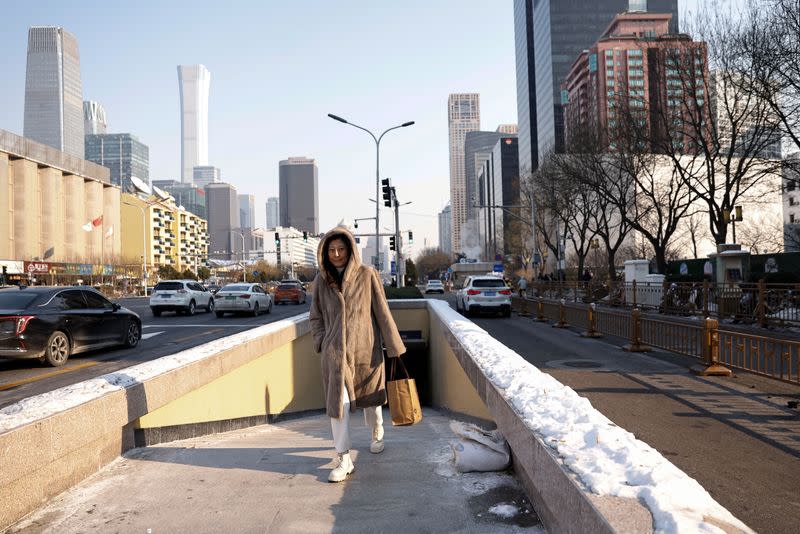 Woman walks on a street in Beijing's CBD on a cold winter day in Beijing