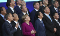 European Union and Asian leaders look up at a drone during a group photo during an EU-ASEM summit in Brussels, Friday, Oct. 19, 2018. EU leaders met with their Asian counterparts Friday to discuss trade, among other issues. (AP Photo/Francisco Seco)