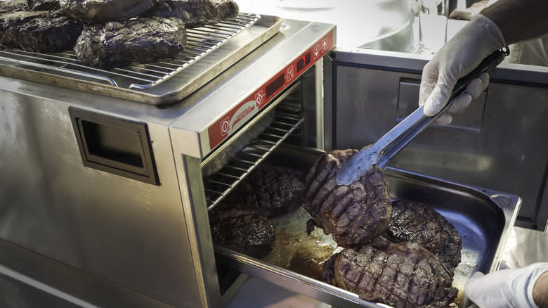 Flipping broiled steaks