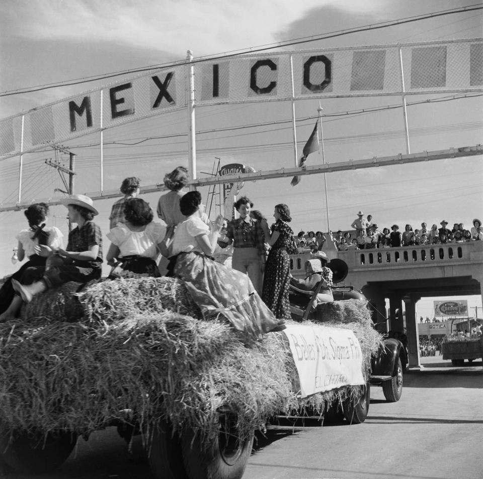 A view of the Sigma Pi sorority crossing under the Mexico border sign to Tijuana, Mexico in Calexico, California.