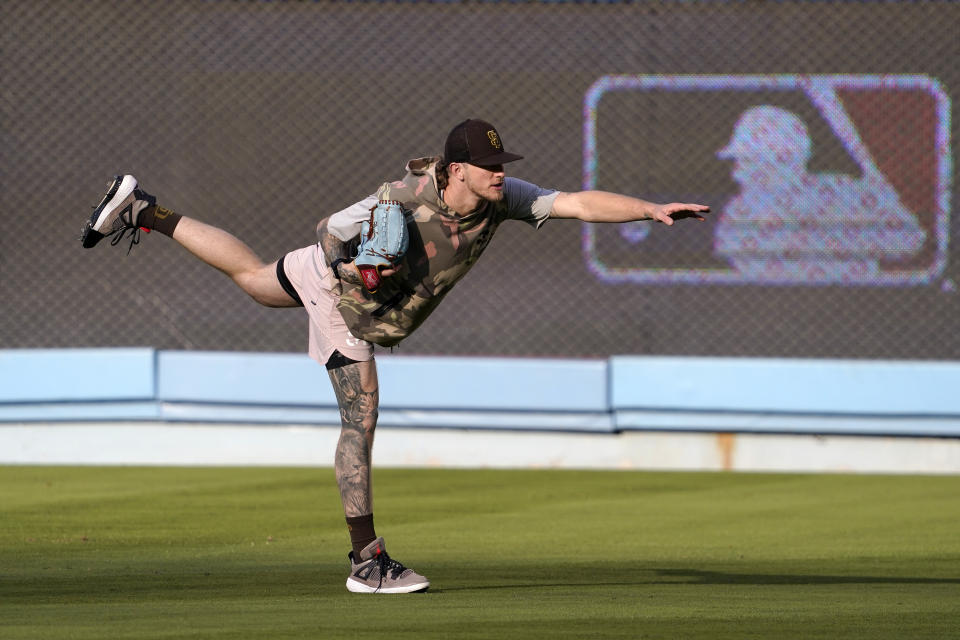 San Diego Padres' pitcher Josh Hader stretches in the outfield during baseball practice Monday, Oct. 10, 2022, in Los Angeles for the National League division series against the Los Angeles Dodgers. (AP Photo/Mark J. Terrill)