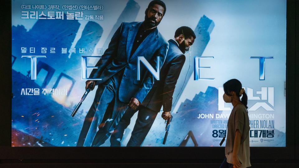 Mandatory Credit: Photo by Simon Shin/SOPA Images/Shutterstock (10757557a)A woman wearing protective mask walks by a billboard of the movie 'TENET'.