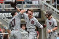 Jun 19, 2018; Omaha, NE, USA; Mississippi State Bulldogs designated hitter Jordan Westburg (11) celebrates a grand slam with third baseman Justin Foscue (17) and shortstop Luke Alexander (7) in the second inning against the North Carolina Tar Heels in the College World Series at TD Ameritrade Park. Mandatory Credit: Steven Branscombe-USA TODAY Sports