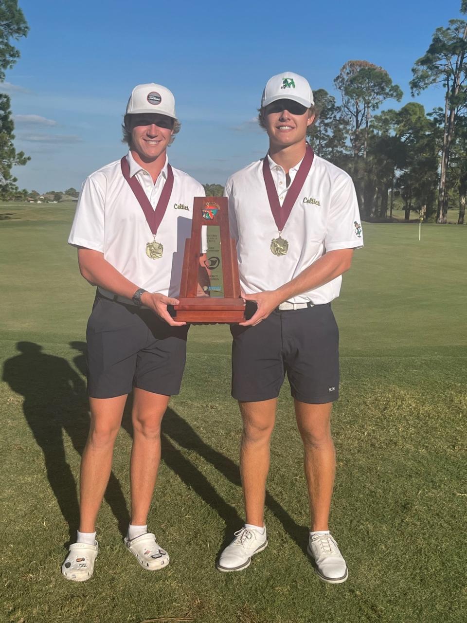 Connor Shea (2nd place) and Callahan Seeber (3rd place) pose with the Class 1A-District 12 boy golf trophy after leading St. John Neumann to a first place finish.