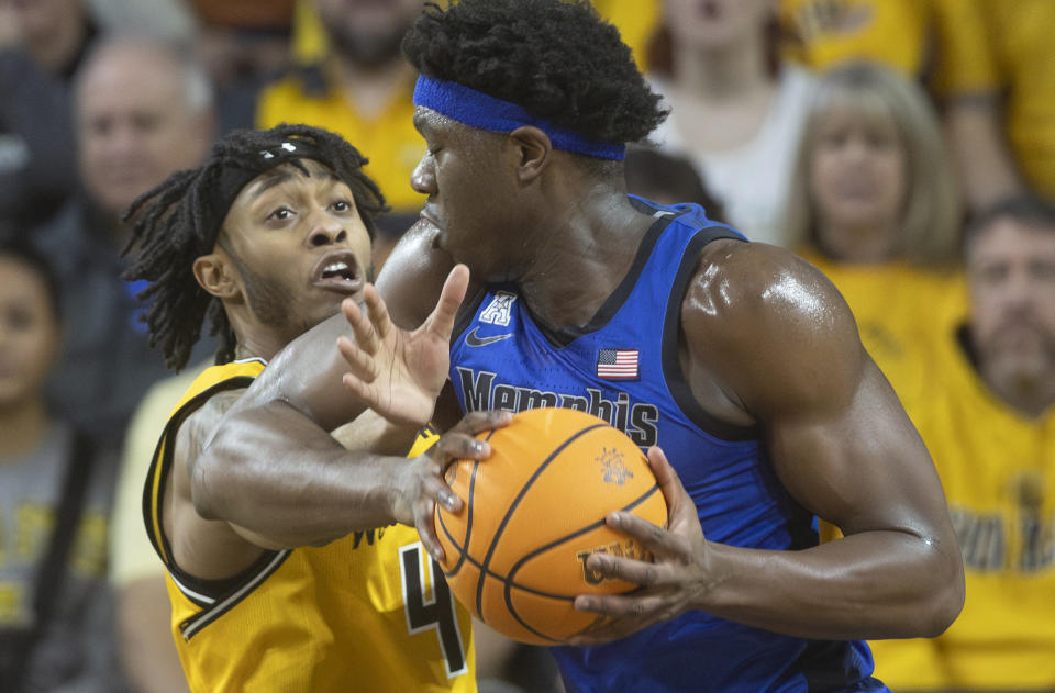 Wichita State's Colby Rogers, left, commits a foul against Memphis' Malcolm Dandridge during the first half of an NCAA college basketball game, Sunday, Jan. 14, 2024, in Wichita, Kan. (Travis Heying/The Wichita Eagle via AP)