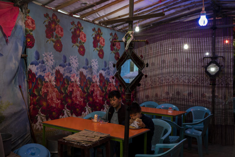 Two boys eat at a local restaurant in Kabul, Afghanistan, Friday, Sept. 10, 2021. (AP Photo/Bernat Armangue)