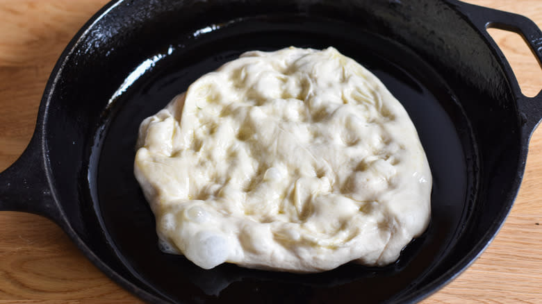 pizza dough in cast iron