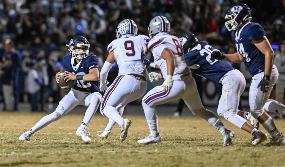 Redwood's Luke Sanchez looks to pass against Mt. Whitney in the 68th annual rivalry Cowhide game Friday, October 27, 2023.