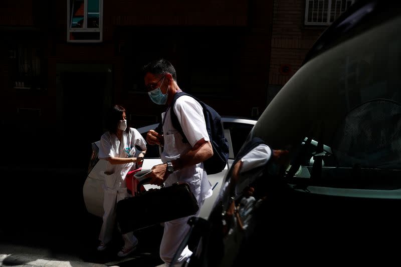 Comunidad de Madrid home care doctor Carlos Balsalobre and nurse Ana Arenal arrive to treat a patient in Madrid