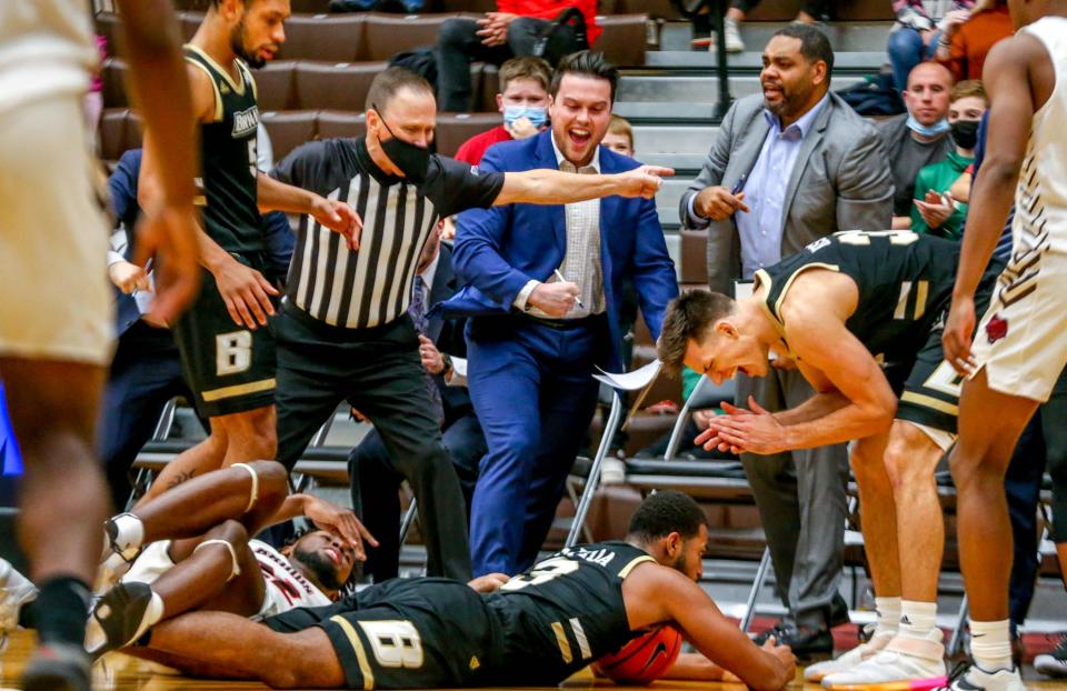 Adham Eleeda maintains Bryant's possession in front of the Bulldogs' bench.