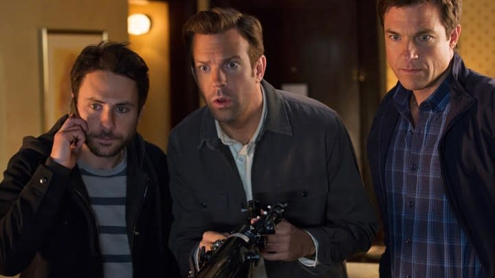 Three men looking at something, surprised in a scene from Horrible Bosses.