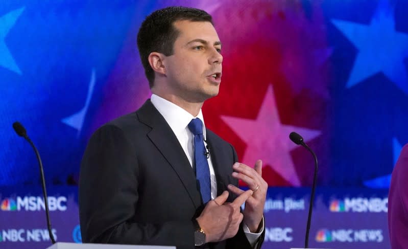 FILE PHOTO: Democratic presidential candidate South Bend Mayor Pete Buttigieg points to his wedding ring from his marriage to his husband Chasten during the U.S. Democratic presidential candidates debate at the Tyler Perry Studios in Atlanta