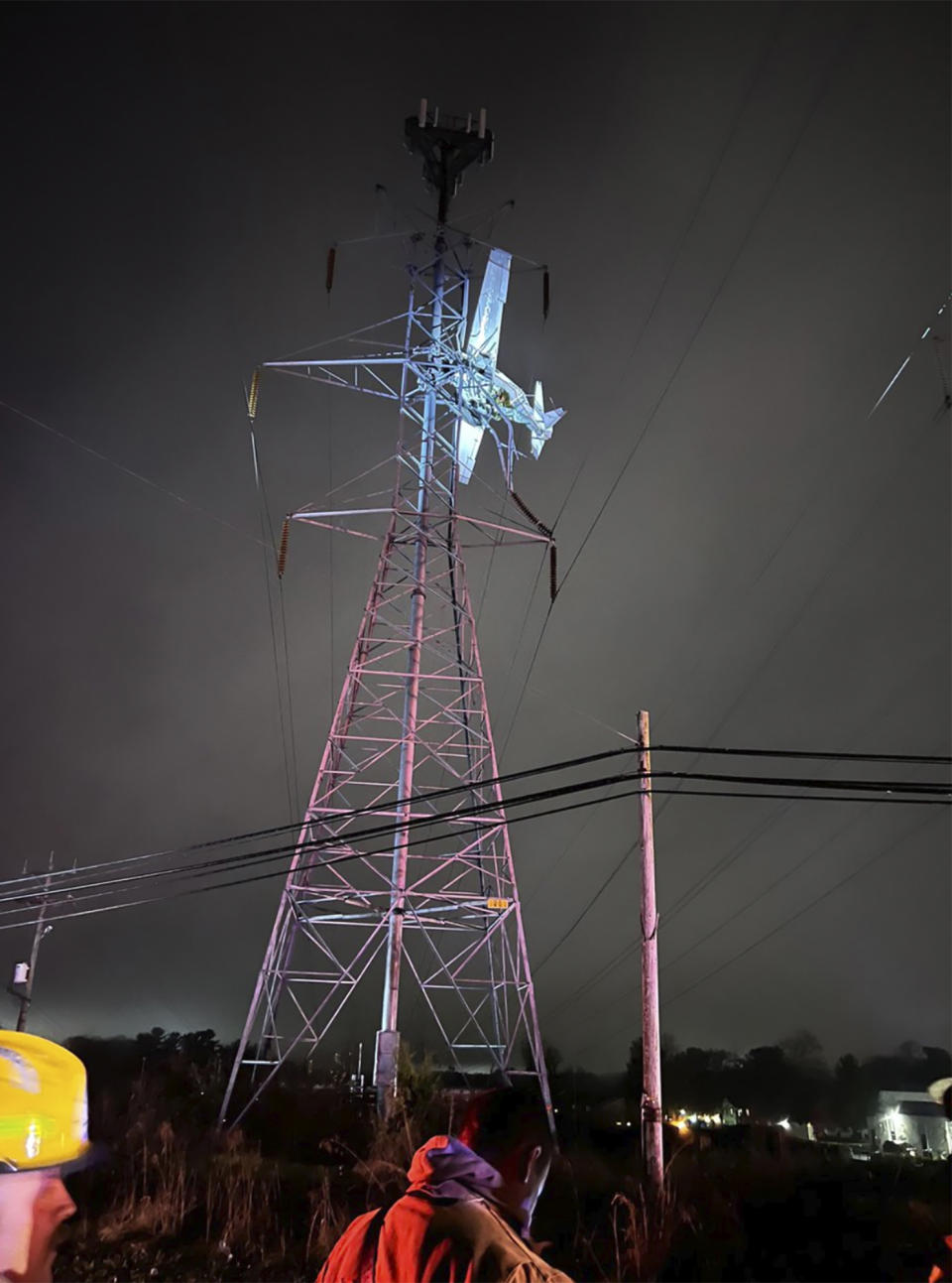 In this photo provided by Montgomery County Fire and Rescue, a small plane rests on live power lines after crashing, Sunday, Nov. 27, 2022, in Montgomery Village, a northern suburb of Gaithersburg, Md. (Pete Piringer/Montgomery County Fire and Rescue via AP)