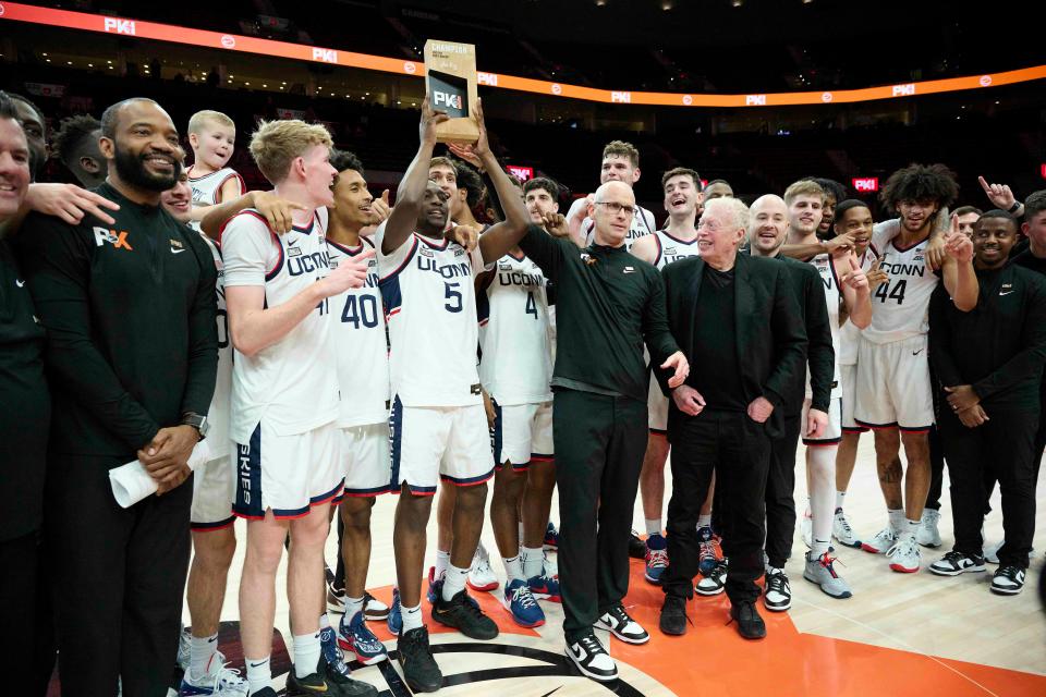 Connecticut Huskies head coach Dan Hurley stands next to Nike founder Phil Knight after beating the Iowa State Cyclones in the Phil Knight men’s basketball Invitational at Moda Center. The Huskies won 71-53. Mandatory Credit: Troy Wayrynen-USA TODAY Sports