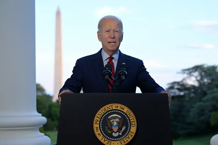  President Biden speaks from the Blue Room Balcony with the Washington Monument in the background.