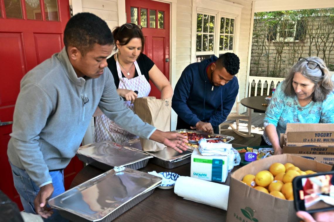 Volunteers prepare food for immigrants outside St. Andrews Episcopal Church on Thursday, Sept. 15, 2022, in Edgartown, Massachusetts, on Martha’s Vineyard. Ron Schloerb/Cape Cod Times via AP