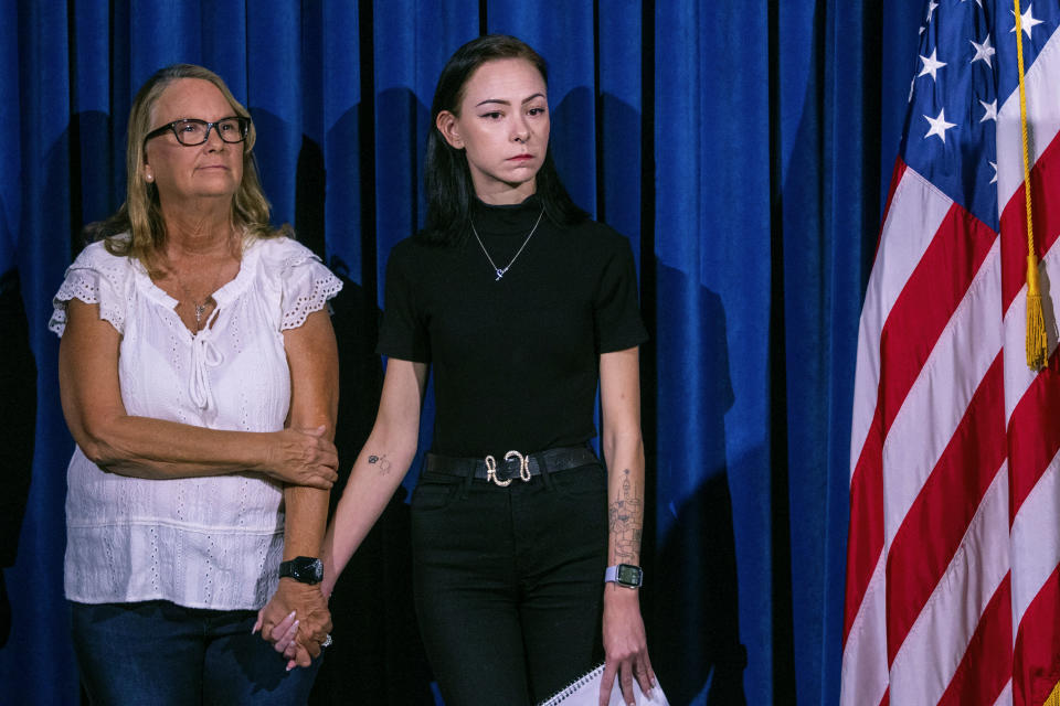 Crystal Probst, left, and her daughter, Taylor Probst, family members of Andreas Rene Probst, a cyclist who was intentionally struck in a series of hit-and-run crashes, wait to speak at a news conference on Tuesday, Sept. 19, 2023, in Las Vegas. Las Vegas police on Tuesday announced a second teenager has been arrested in the series of hit-and-run crashes, including the death of a former California police chief who was riding a bicycle last month. (AP Photo/Ty ONeil)