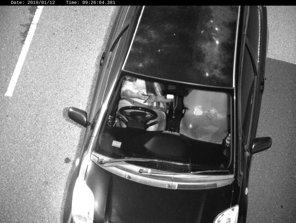 Photo released by Transport for NSW shows a driver using a mobile phone while driving in Australia.