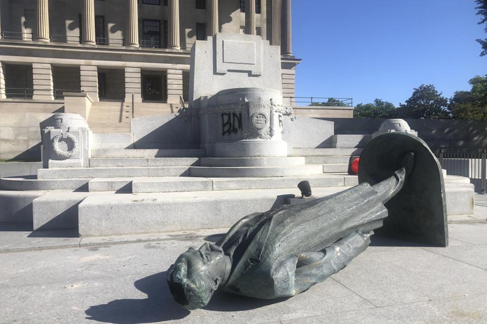 Protesters toppled the statue of Edward Carmack outside the state Capitol after a peaceful demonstration turned violent, Sunday, May 31, 2020, in Nashville, Tenn. (Kimberlee Kruesi/AP Photo)