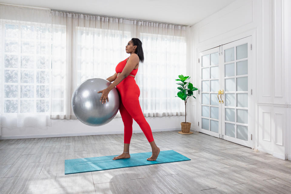 Woman exercising on a fitness ball at home