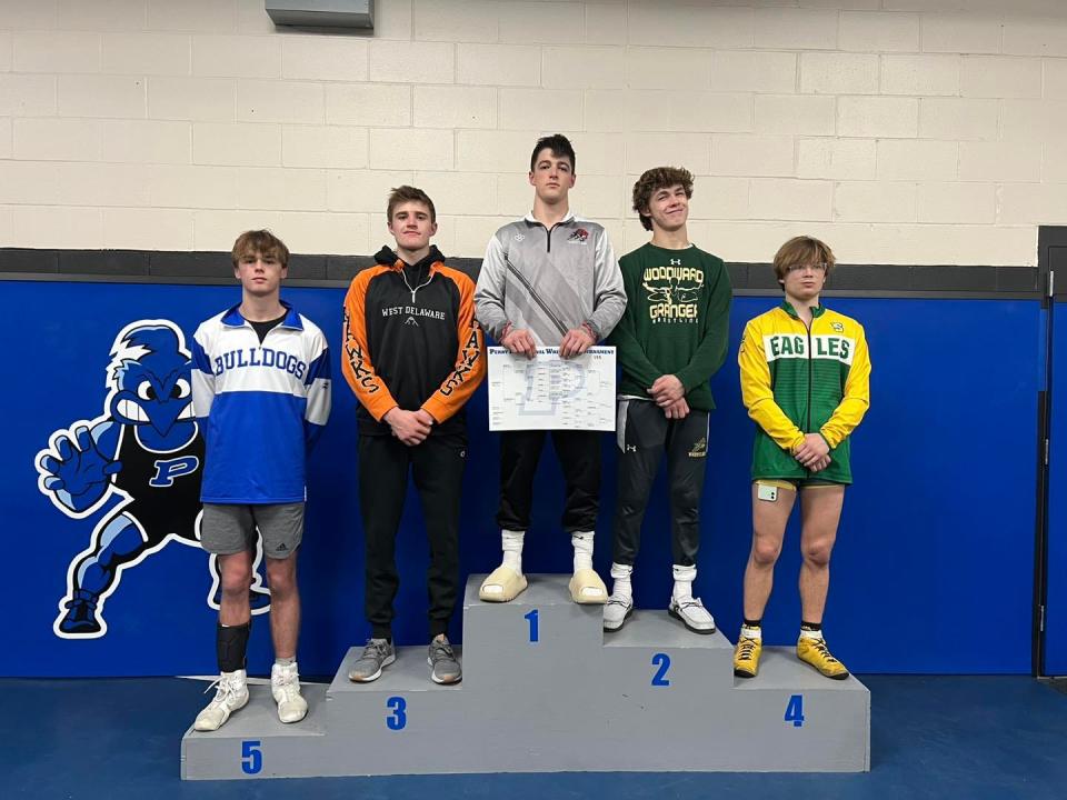 Van Meter's Mason Drake poses for a photo after taking fifth place during the Perry Boys Wrestling Invitational on Saturday, Jan. 14, 2023.