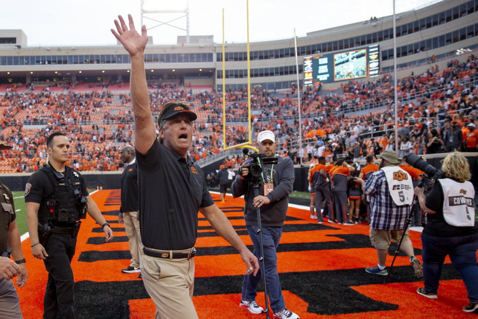 Oklahoma State head coach Mike Gundy waves to the crowd after an NCAA college football game against Texas Tech in Stillwater, Okla., Saturday, Oct. 8, 2022. (AP Photo/Mitch Alcala)