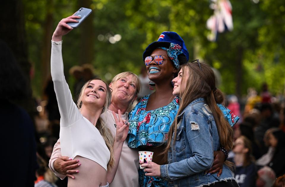 People take a selfie by The Mall ahead of a concert outside Buckingham Palac (REUTERS)
