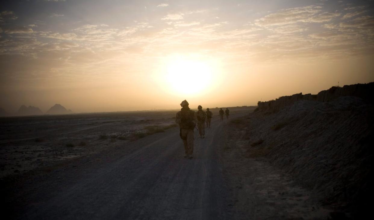 Canadian soldiers patrol in the early morning outside Salavat, southwest of Kandahar, Afghanistan, on Saturday, Sept. 11, 2010. Canadian soldiers were deployed to Kandahar province as part of the country’s mission in Afghanistan. Canada's combat role ended in 2011. (Anja Niedringhaus/The Associated Press - image credit)