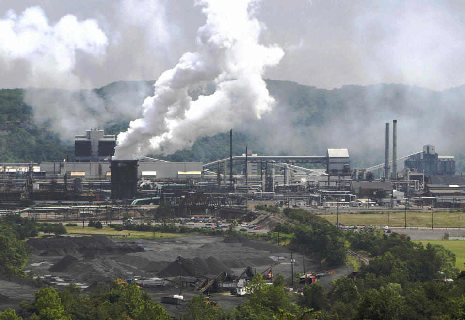 FILE- This file photo from July 14, 2010 shows smoke pouring from the United States Steel Corp.'s Clairton Coke Works in Clairton, Pa. A fire at U.S. Steel's massive coke plant outside Pittsburgh knocked a key pollution control system offline Monday, June 17, 2019. It triggered a health warning as officials monitored the air around the plant for signs of a release of toxic sulfur dioxide. It was the second fire since December at the coke works, the largest facility of its kind in the United States. The plant turns coal into coke, one of the raw materials of steel. (AP Photo/Keith Srakocic, File)