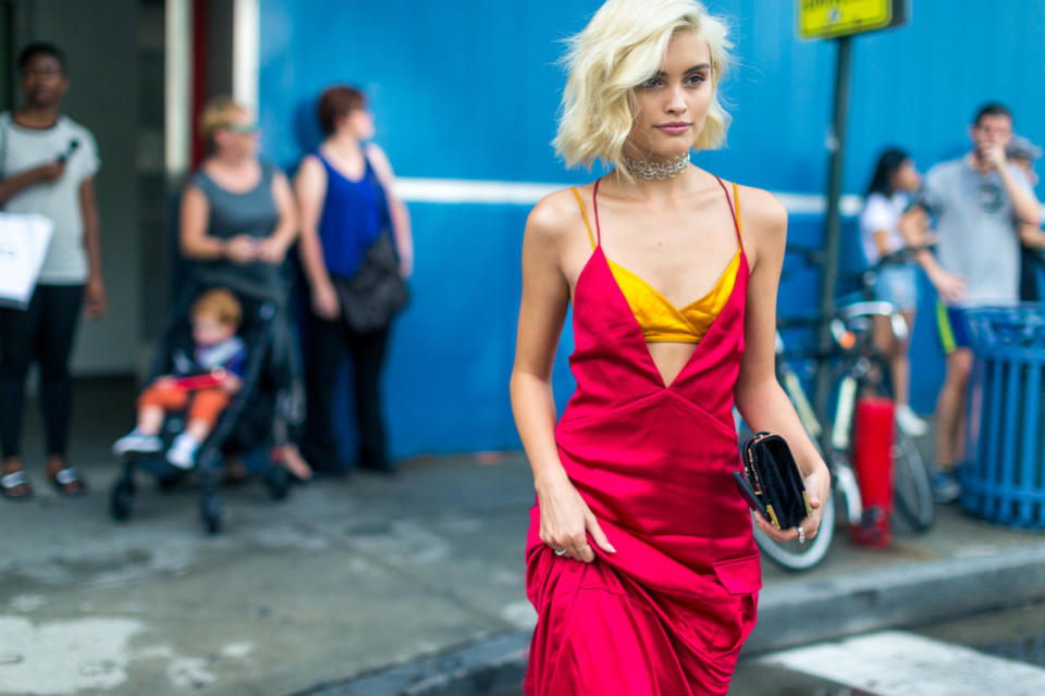 With her deep-V slip dress and dainty, dark clutch, this showgoer makes the ultimate case for evening wear in the daytime at New York Fashion Week.