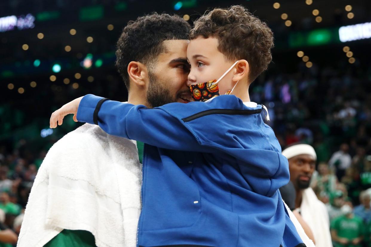 Jayson Tatum #0 of the Boston Celtics celebrates with his son, Jayson “Deuce” Christopher Tatum Jr., after defeating the Milwaukee Bucks 109-81 in Game Seven of the 2022 NBA Playoffs Eastern Conference Semifinals at TD Garden on May 15, 2022 in Boston, Massachusetts.