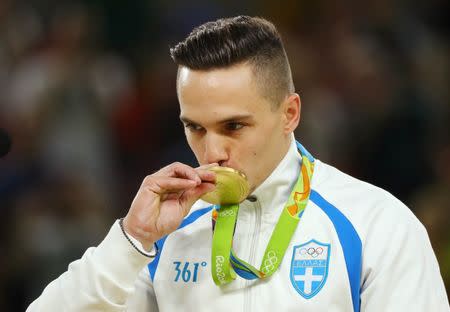 2016 Rio Olympics - Artistic Gymnastics - Victory Ceremony - Men's Rings Victory Ceremony - Rio Olympic Arena - Rio de Janeiro, Brazil - 15/08/2016. Eleftherios Petrounias (GRE) of Greece kisses his gold medal. REUTERS/Mike Blake