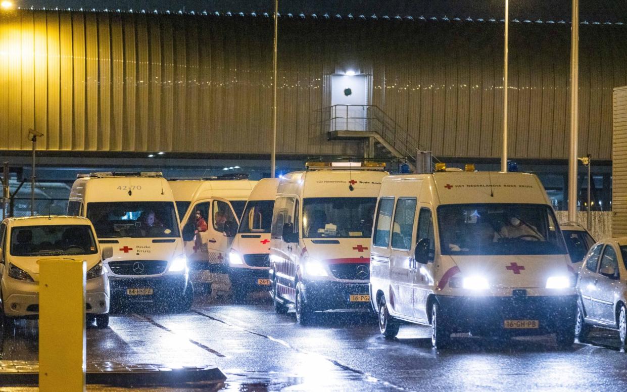 Health workers of the Red Cross transport passengers infected with coronavirus returning from South Africa - LAURENS BOSCH/Shutterstock