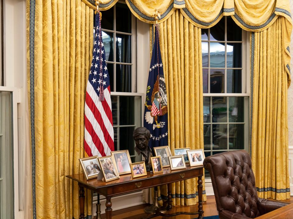 A table with family photos behind Joe Biden’s desk in the Oval Office of the White HouseAP