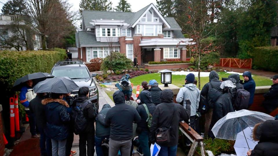 Los medios de comunicación se paran frente a la casa de Meng Wanzhou.