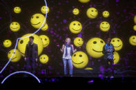 Images are displayed across a scrim as actors perform during the opening of the keynote address by Qualcomm CEO Paul Jacobs at the Consumer Electronics Show.