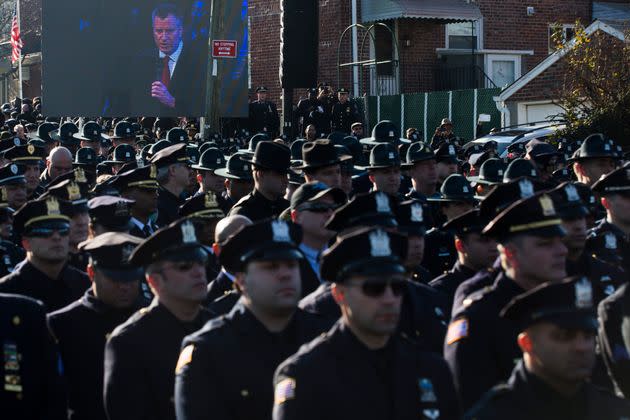 Police officers turn their backs as then-New York City Mayor Bill de Blasio speaks at the funeral of two slain NYPD officers in December 2014. (Photo: John Minchillo/Associated Press)