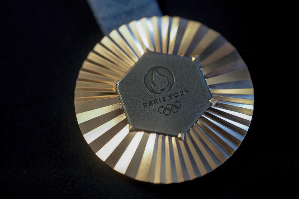 The Paris 2024 Olympic silver medal is presented to the press, in Paris, Thursday, Feb. 1, 2024. A hexagonal, polished piece of iron taken from the Eiffel Tower is being embedded in each gold, silver and bronze medal that will be hung around athletes' necks at the July 26-Aug. 11 Paris Games and Paralympics that follow. (AP Photo/Thibault Camus)