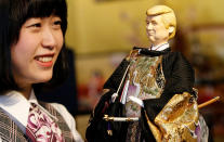 <p>An employee of Japanese doll-maker Kyugetsu Inc poses with a doll depicting U.S. President Donald Trump, as part of a traditional set of Japanese ornamental hina dolls used in Japan to celebrate Girls’ Day, at the company’s main shop in Tokyo, Japan, Jan. 26, 2017. (Photo: Toru Hanai/Reuters) </p>