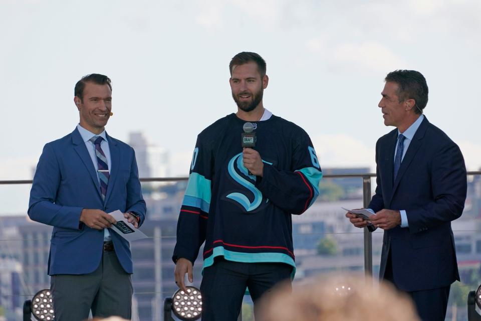 Goalie Chris Dreidger stands with ESPN NHL expansion draft hosts Dominic Moore and Chris Fowler.