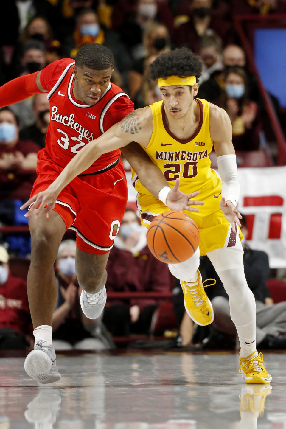 Ohio State forward E.J. Liddell (32) fouls Minnesota guard Eylijah Stephens (20) in the first half of an NCAA college basketball game Thursday, Jan. 27, 2022, in Minneapolis. (AP Photo/Bruce Kluckhohn)