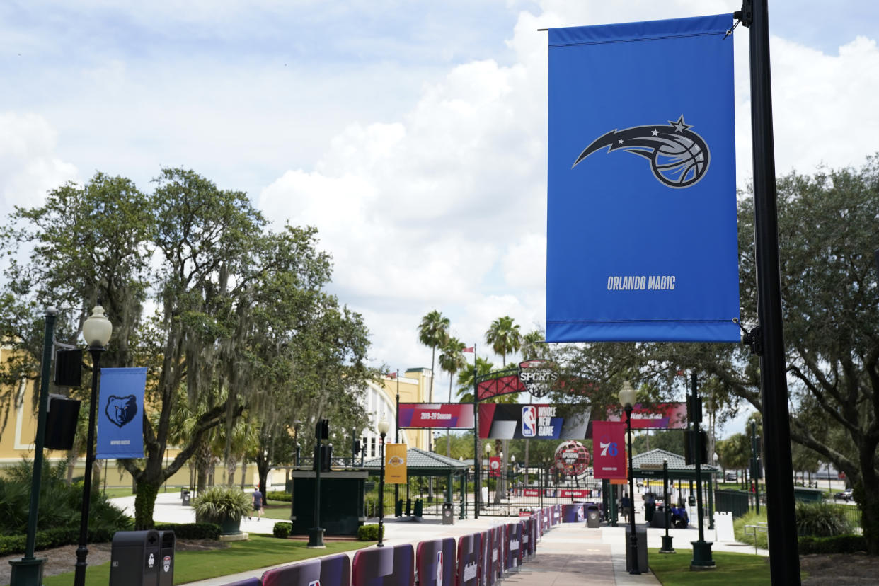An Orlando Magic banner, along with other NBA basketball team logos are displayed outside arenas Friday, Aug. 28, 2020, at Walt Disney World in Lake Buena Vista, Fla. (AP Photo/Ashley Landis, Pool)