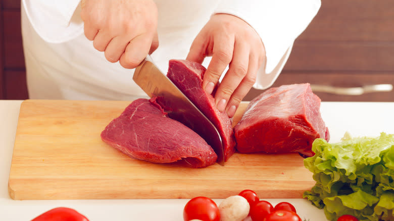 chef cutting beef tenderloin