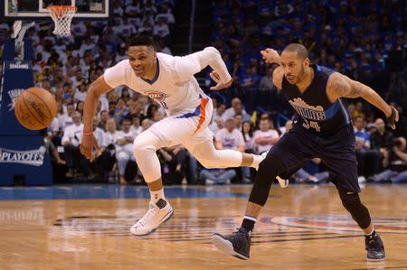 Apr 16, 2016; Oklahoma City, OK, USA; Dallas Mavericks guard Devin Harris (34) fouls Oklahoma City Thunder guard Russell Westbrook (0) during the third quarter in game one of their first round NBA Playoffs series at Chesapeake Energy Arena. Mandatory Credit: Mark D. Smith-USA TODAY Sports