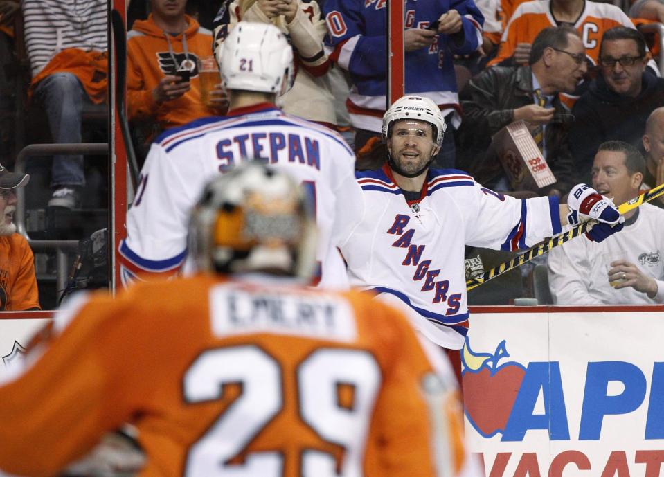 New York Rangers' Martin St. Louis, right, looks to celebrate his goal with Derek Stepan, middle, as Philadelphia Flyers goalie Ray Emery watches during the first period in Game 3 of an NHL hockey first-round playoff series, Tuesday, April 22, 2014, in Philadelphia. (AP Photo/Chris Szagola)