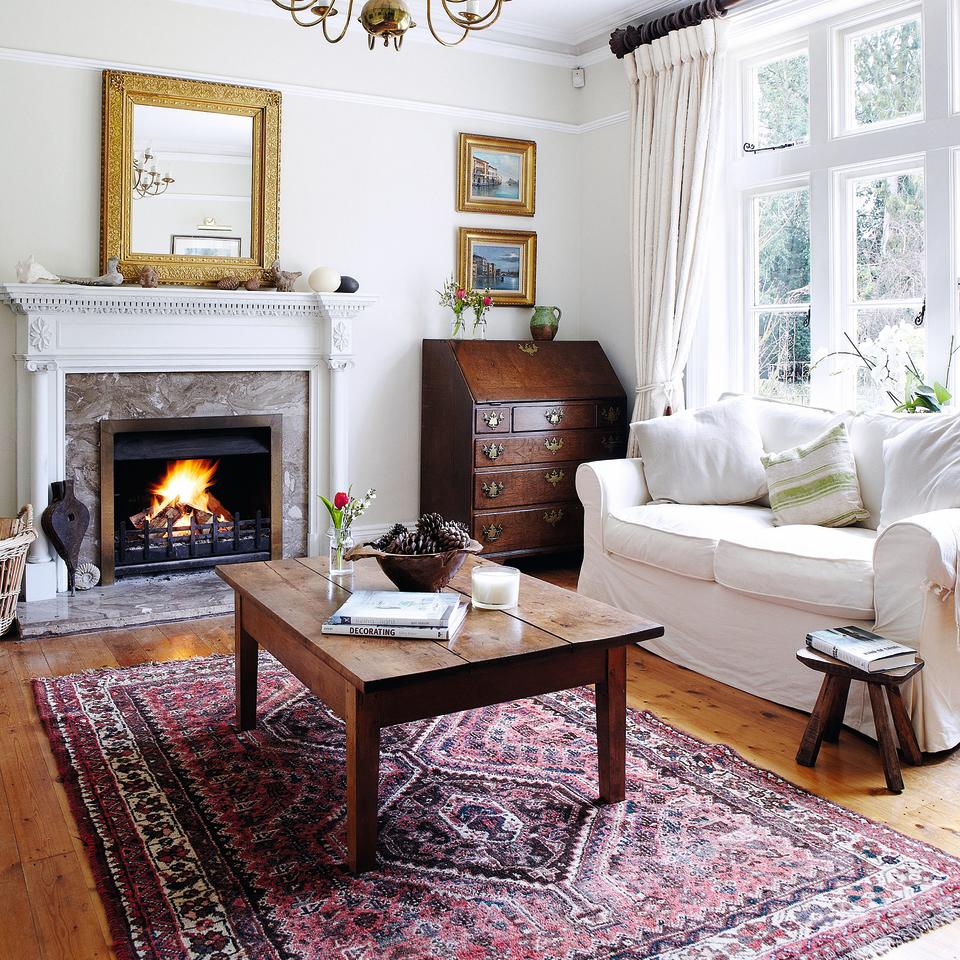 Living room with antique pink and red rug.