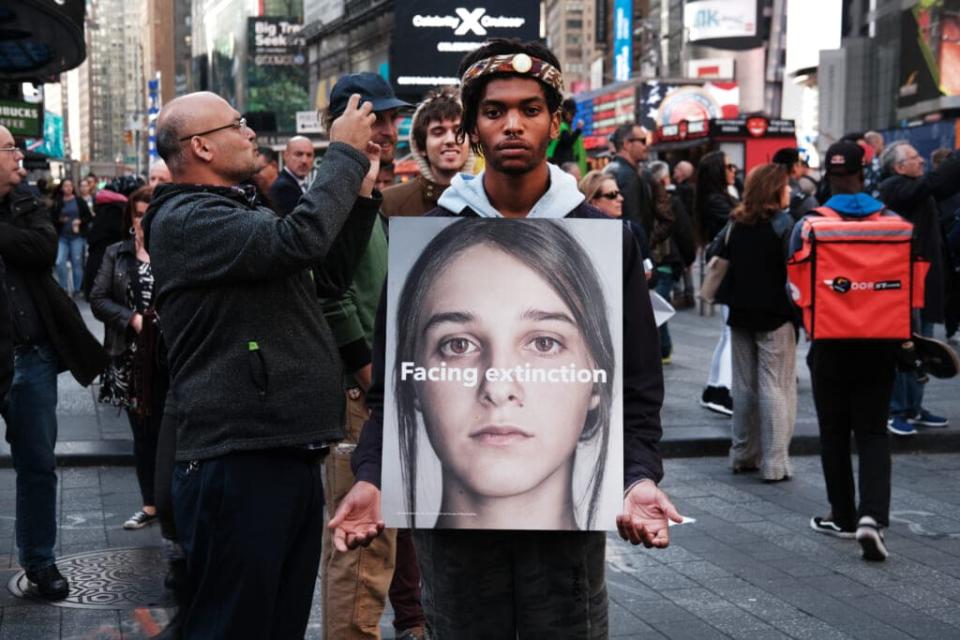 Protesters gather around a small sailboat that was dropped off in Times Square as part of a protest by the environmental group Extinction Rebellion on October 10, 2019 in New York City. (Photo by Spencer Platt/Getty Images)