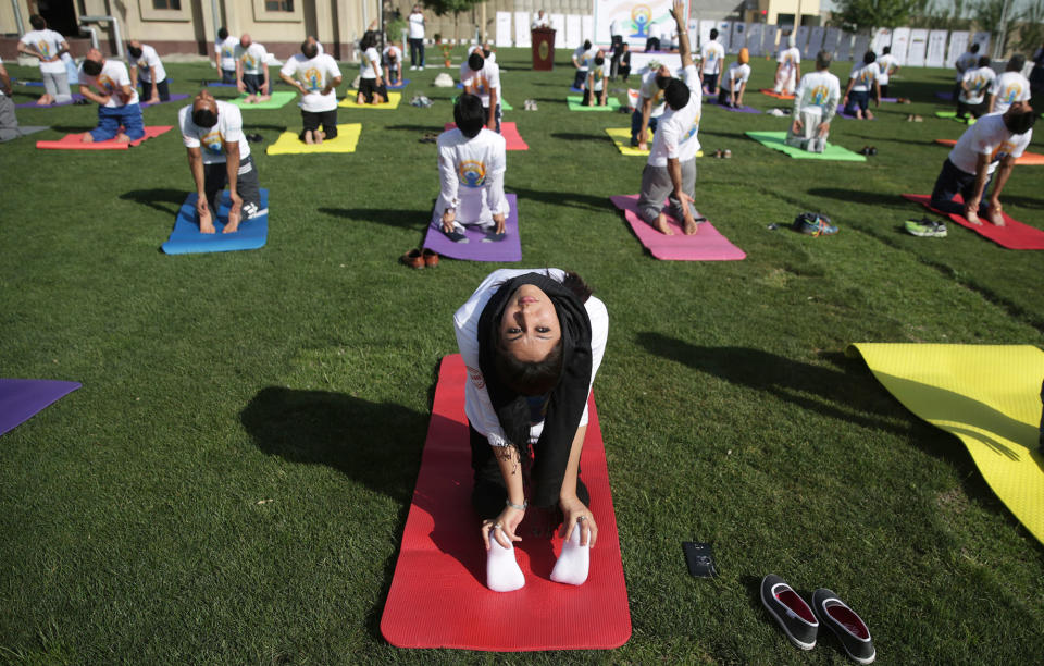 <p>Afghans and foreigners perform yoga to mark International Yoga Day at the Indian Embassy, in Kabul, Afghanistan, Wednesday, June 21, 2017. (Photo: Massoud Hossaini/AP) </p>